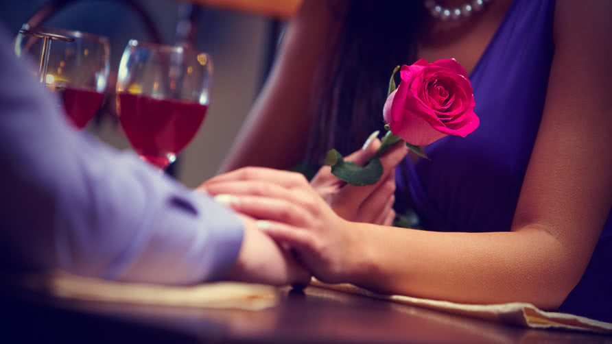 female hand holding a rose