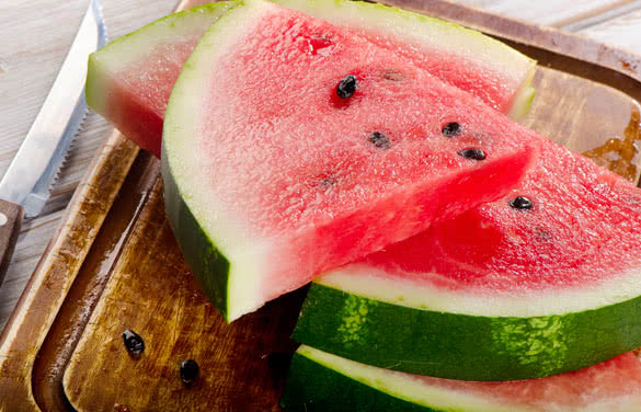 slices of watermelon on wooden table