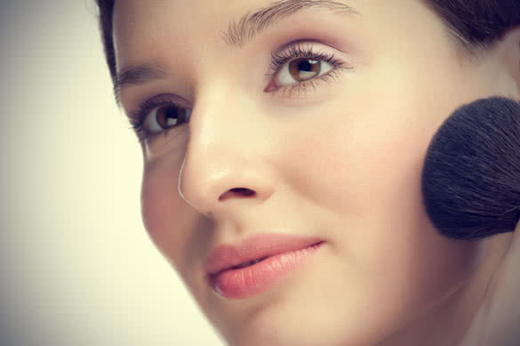 young beautiful woman with brush for makeup