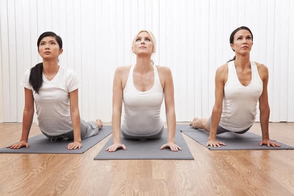 three beautiful young women in a yoga position