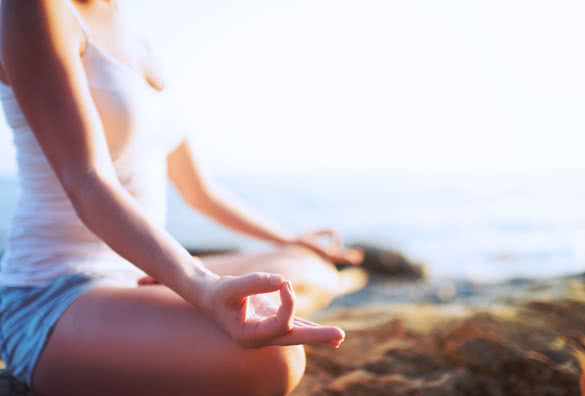 hand of a woman meditating in a yoga pose