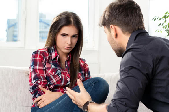 quarreled young couple in their living room