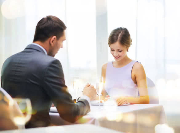 smiling couple eating dessert at restaurant