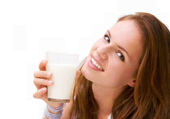 young beautiful woman with a glass of milk