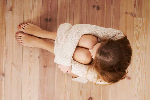 Beautiful caucasian woman is sitting on the floor