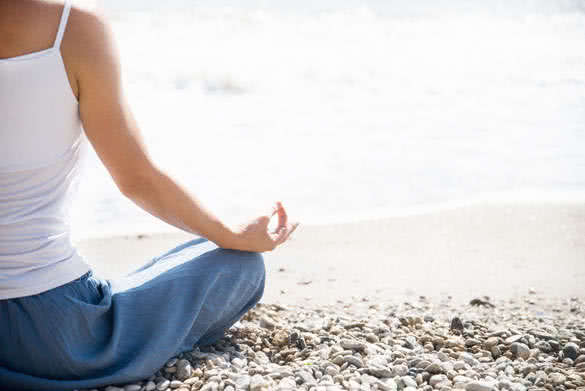 Woman meditating at beach