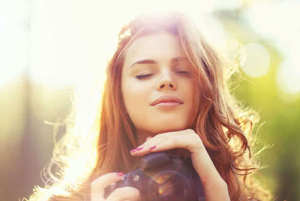 Young woman with camera outdoors portrait