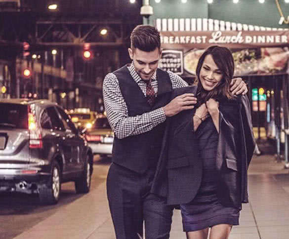 man giving his jacket to his girlfriend