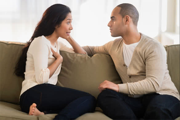 couple-having-conversation-in-the-living-room