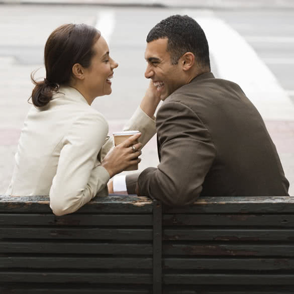 couple-sitting-on-the-bench-and-smiling