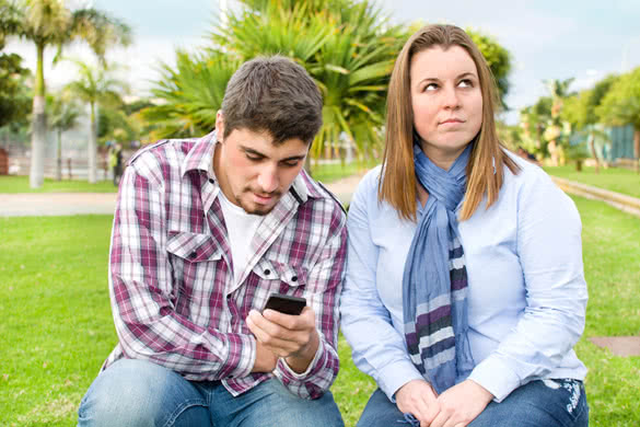 man-looking-mobile-phone-and-angry-girlfriend