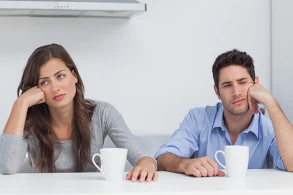 sad-couple-sitting-at-the-table