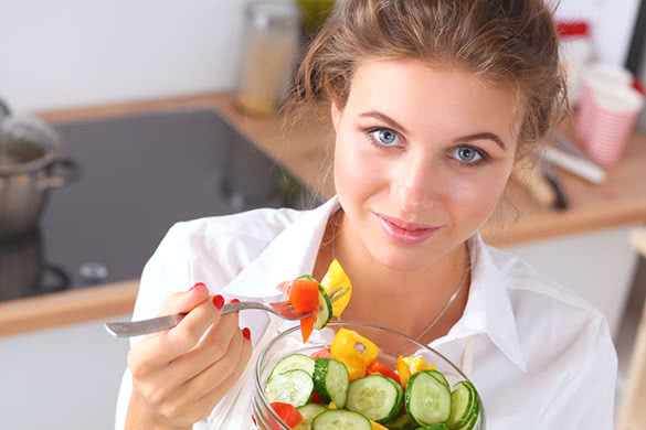 woman-eating-fresh-salad-in-the-kitchen