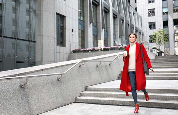 stylish woman wearing red coat and red booties