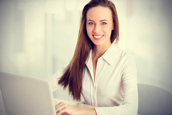 Smiling business woman in white shirt at the office