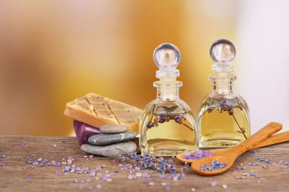 Spa still life with lavender oil and flowers on wooden table