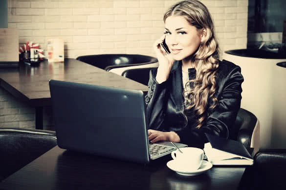 Young business woman having a break at a cafe