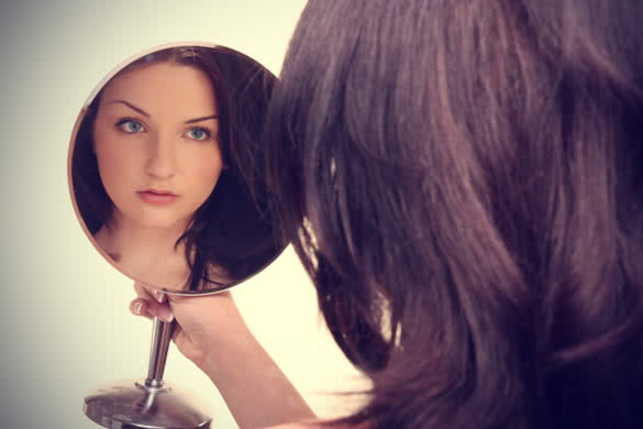 woman looking in mirror