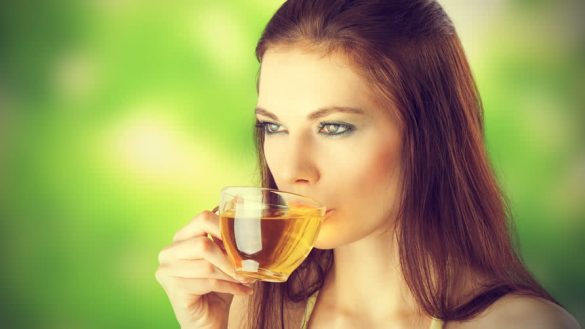 young pretty brunette drinking green tea