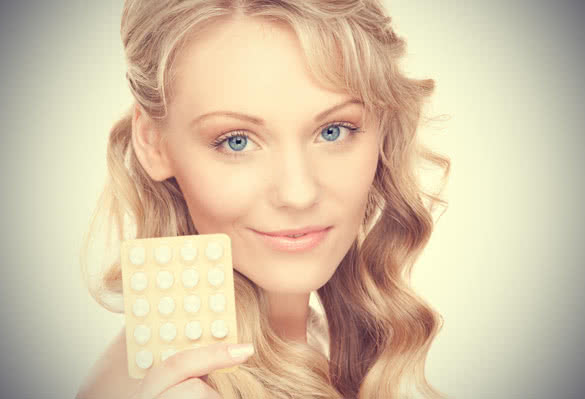 Woman Holding Birth Control Pills