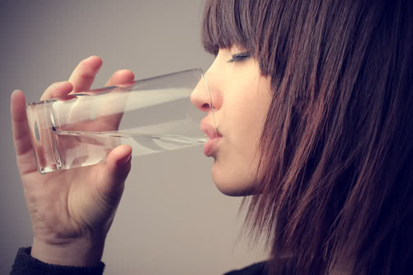 Young woman drinking a glass of water