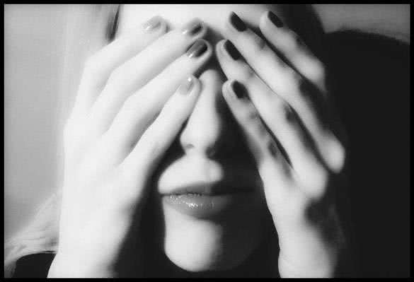 girl covering her eyes with hands