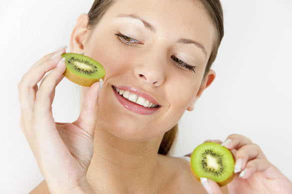 portrait of young woman with kiwi