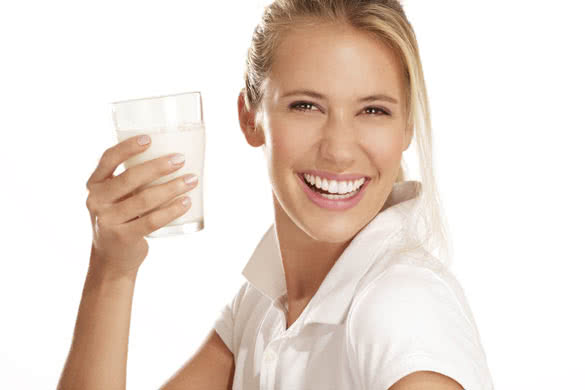 young woman drink milk and smiling