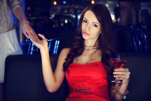 beautiful girl with drink in a night club