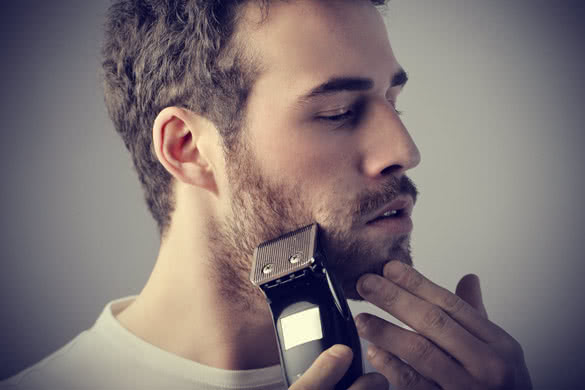 man shaving his beard