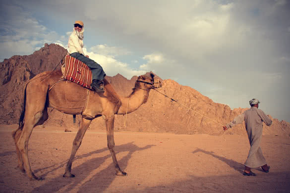 woman riding camel in egypt