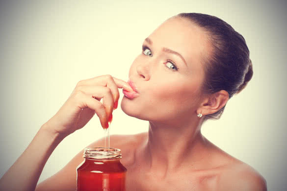 Pretty Young Girl Eating Honey