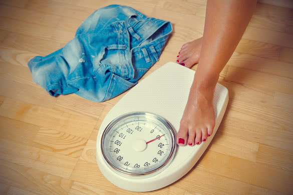 Womans feet on a weight loss scale