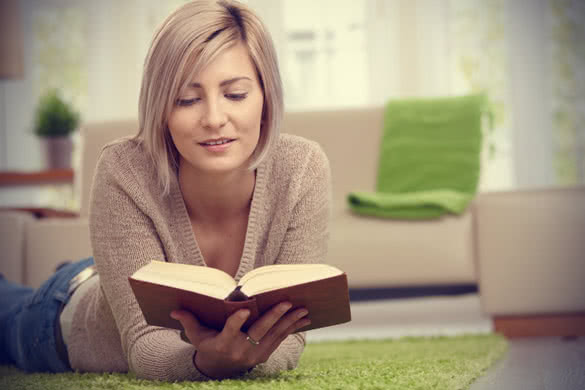 Young Woman Reading Book At Home