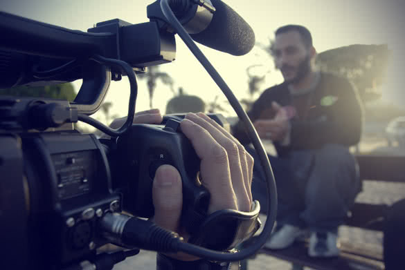 artist and cameraman filming in daylight