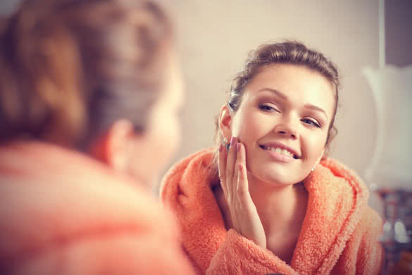 beautiful woman in bath in the morning looking at the mirror