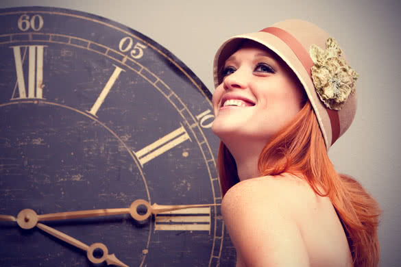 beautiful young woman in front of an antique clock