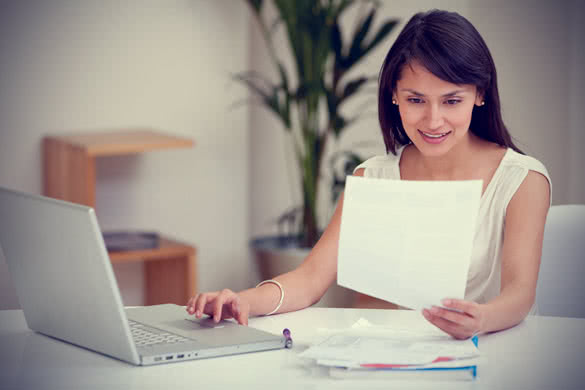 businesswoman with laptop and papers