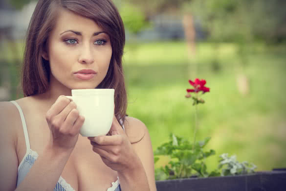 cute teenage girl with cup of coffee on the terrace