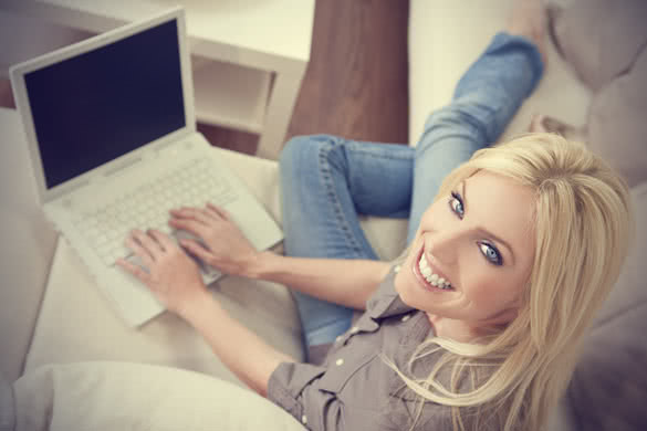 smiling blonde woman with laptop