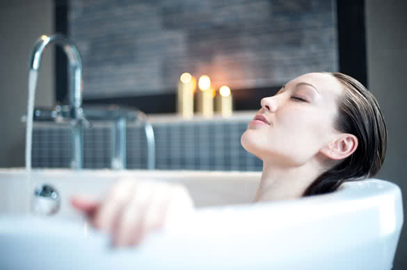 Attractive mixed asian woman relaxing in bath