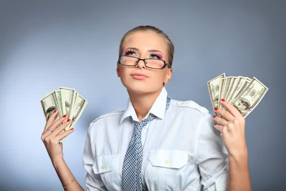 Beautiful businesswoman holding money