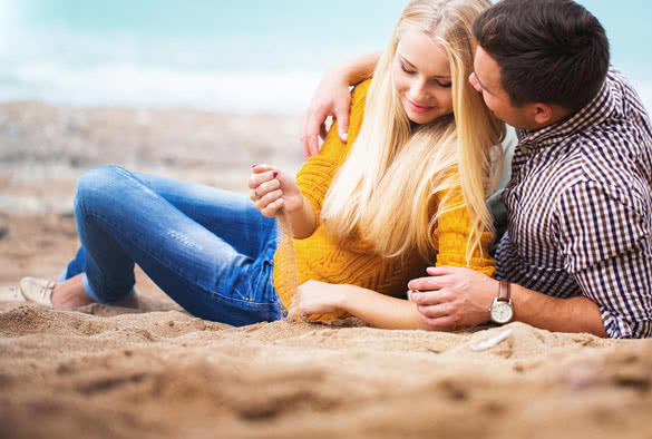 Couple relaxing on the autumn beach