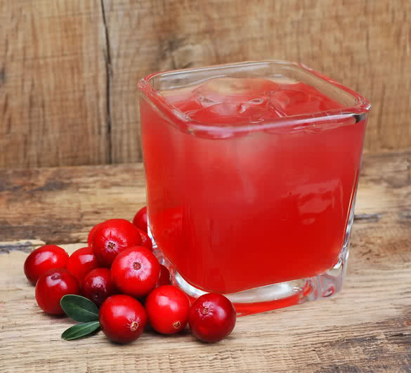 Cranberry drink on wooden table