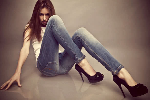 Young Woman Wearing Jeans And Black High Heels