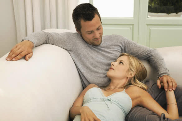 Young couple relaxing on sofa at home