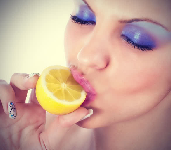 Young women eating lemon