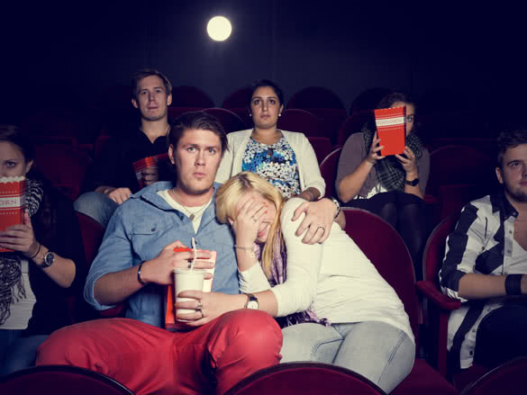 scared girl with her boyfriend in cinema