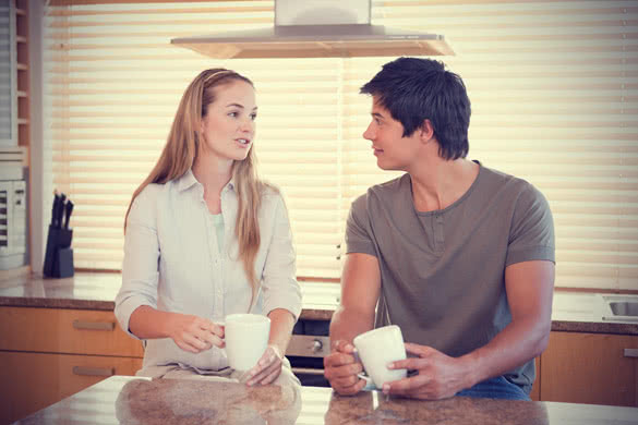 talking couple sitting in kitchen