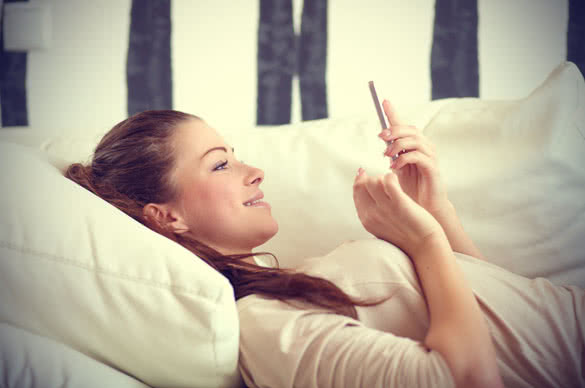 young girl smiling and texting